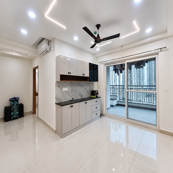 Modern apartment, luxury interior, contemporary home, living room, modular kitchen, open kitchen, kitchen cabinets, marble backsplash, black countertop, white cabinets, spacious room, bright interior, elegant home, residential apartment, high rise apartment, city view, balcony, glass sliding doors, large windows, ceiling fan, air conditioner, LED ceiling lights, false ceiling, glossy floor tiles, tiled flooring, minimalist design, modern architecture, clean interior, furnished apartment, premium apartment, urban living, stylish home, kitchen island, storage cabinets, built-in kitchen, modern lighting, natural light, balcony railing, city skyline, high-rise buildings, neat interior, white walls, black fixtures, modern home decor, luxury real estate, apartment for rent, property interior, spacious kitchen, contemporary lifestyle, polished flooring, residential property.